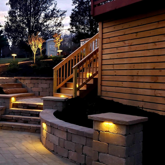 Deck Lighting steps, patio and stone seating with lighting at dusk