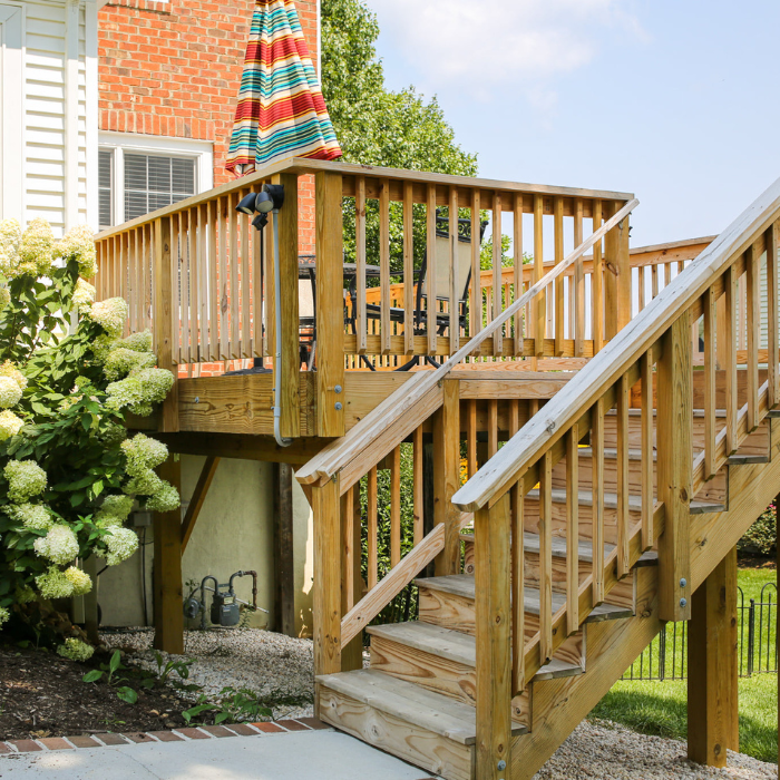 Deck Replacement deck with stairs leading to patio with hydrangeas